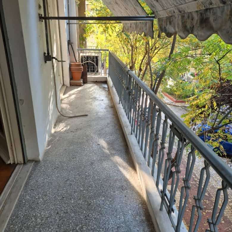 Balcony of a Kypseli Athens apartment with metal railing and outdoor space.