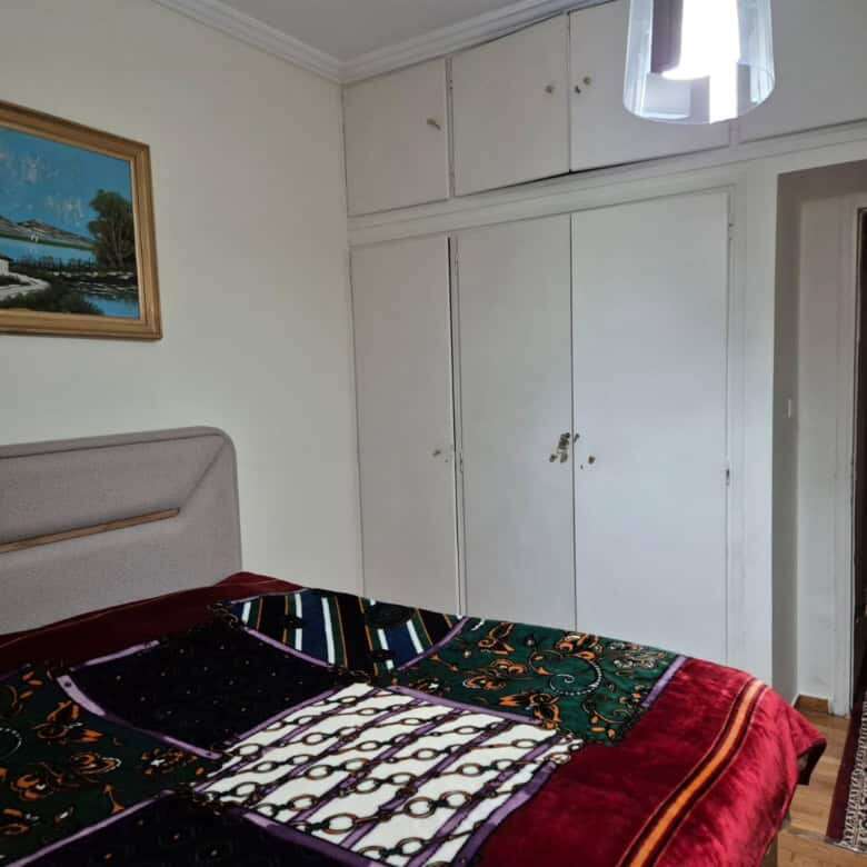 Bright interior of a 3-bedroom apartment in Kypseli, Athens, featuring a comfortable bedroom and acc.