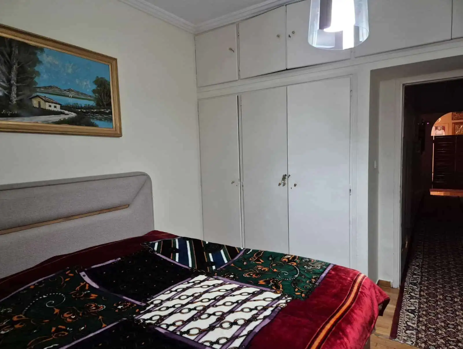 Bright interior of a 3-bedroom apartment in Kypseli, Athens, featuring a comfortable bedroom and acc.