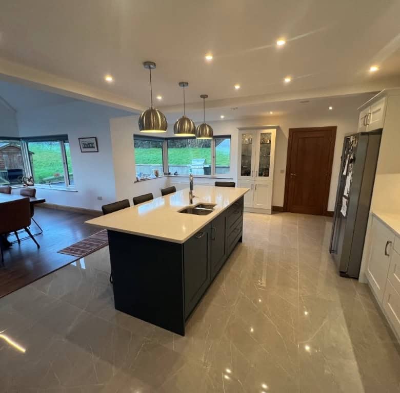 Spacious contemporary kitchen featuring a central island, sleek cabinetry, and large windows with sc.