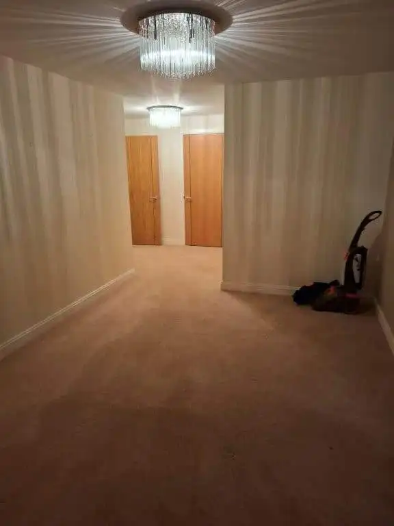 Spacious 2-bedroom apartment with neutral decor and elegant lighting fixtures in Hampshire, UK.