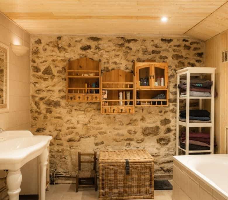 Cozy bathroom featuring rustic stone walls and wooden accents in a 6-bed estate in La Celle-sur-Mori.