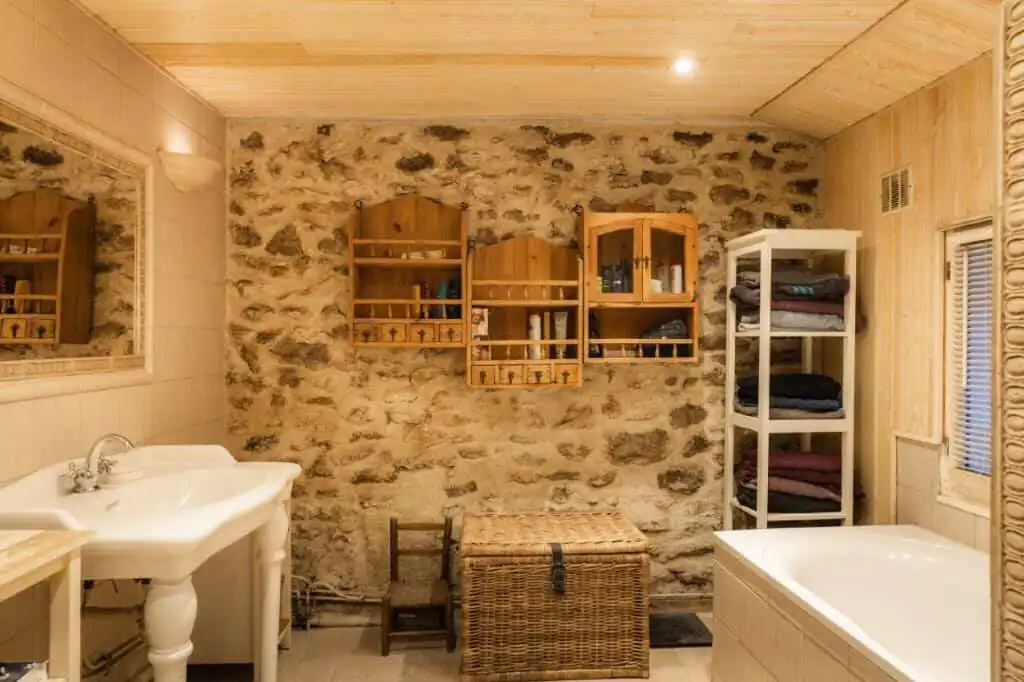Cozy bathroom featuring rustic stone walls and wooden accents in a 6-bed estate in La Celle-sur-Mori.