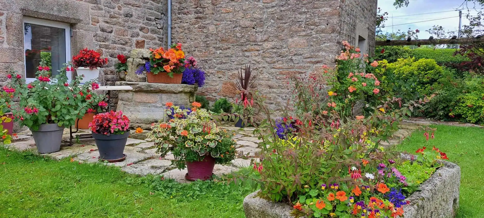 Beautiful garden with vibrant flowers and lush greenery at a luxury estate in Scaer, Brittany.