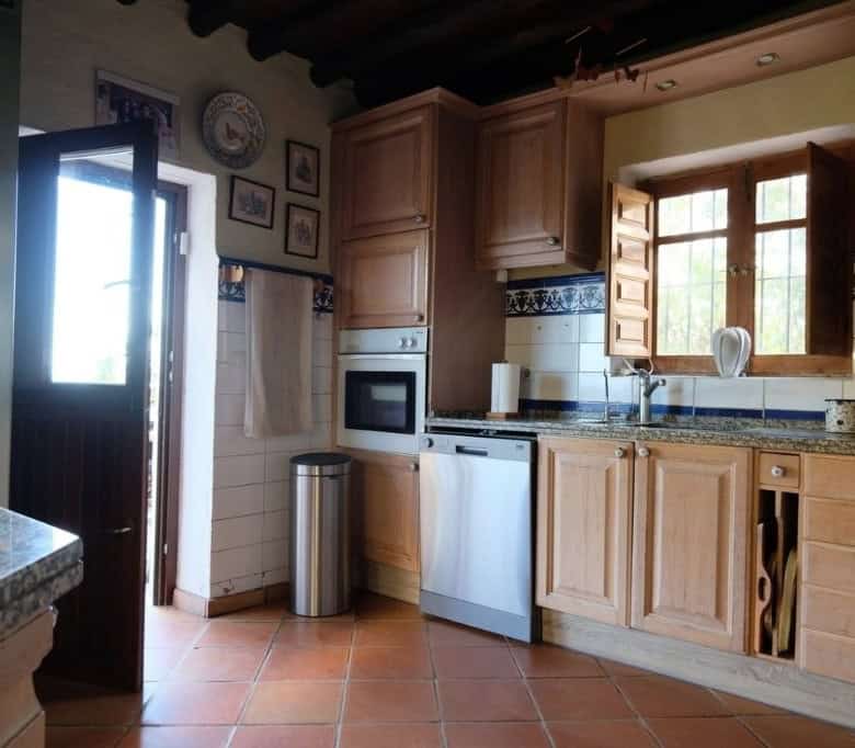 Beautiful kitchen in La Casa de la Panzona finca, Estepona, Spain, with wooden cabinets and traditio.