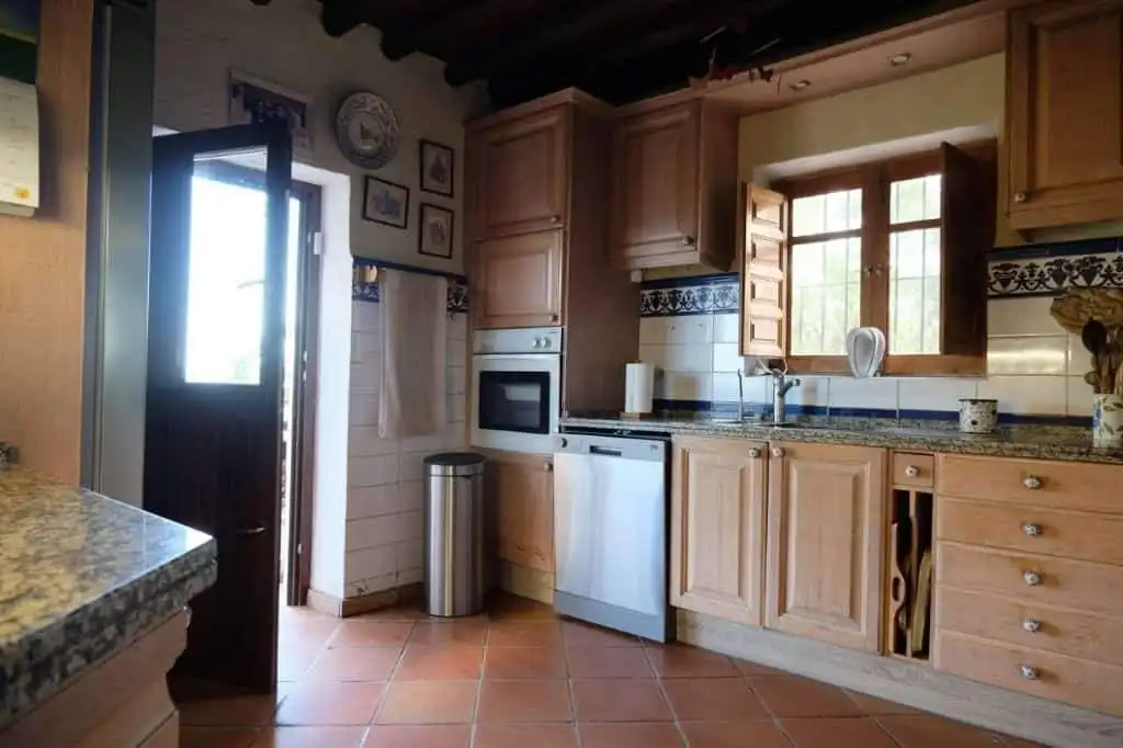 Beautiful kitchen in La Casa de la Panzona finca, Estepona, Spain, with wooden cabinets and traditio.