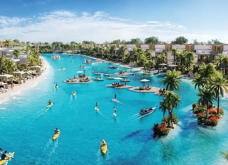 Scenic view of a luxury waterfront resort with boats, palm trees, and clear blue water.