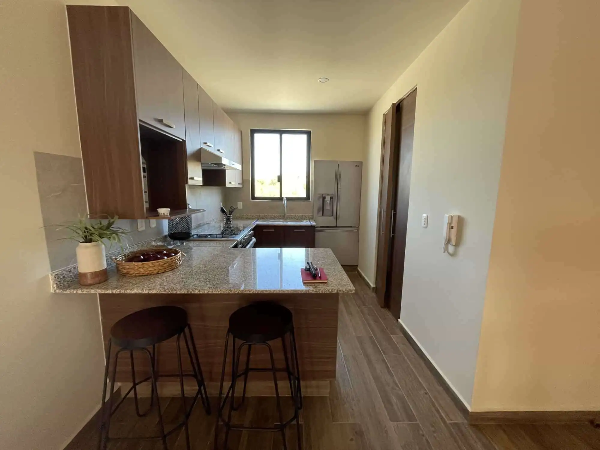 Interior view of a modern 2-bedroom rooftop home in San Miguel de Allende with kitchen and seating a.