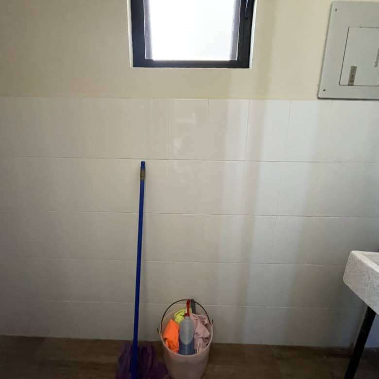 Interior view of a small laundry area in a rooftop home in San Miguel de Allende, featuring a window.