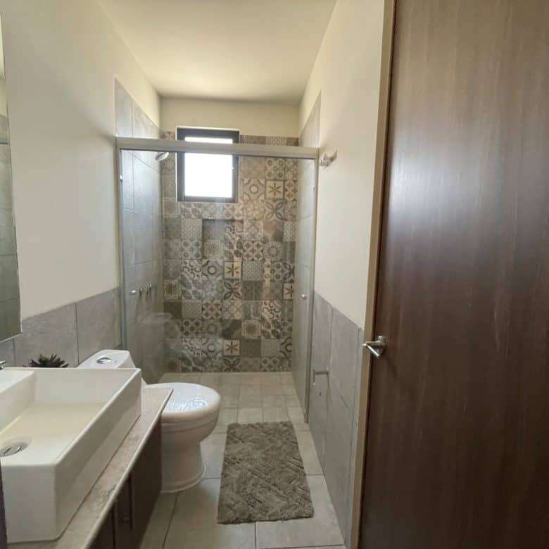 Bright bathroom with modern fixtures and decorative tile accents in San Miguel de Allende.