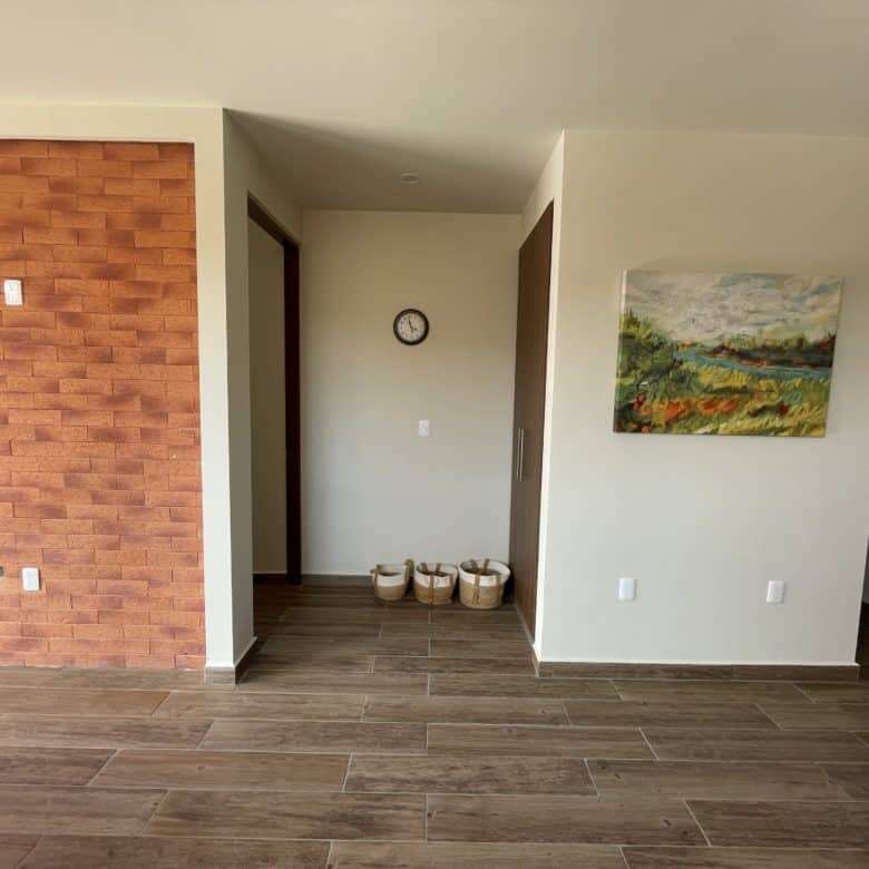 Spacious living area with stylish decor and natural light.