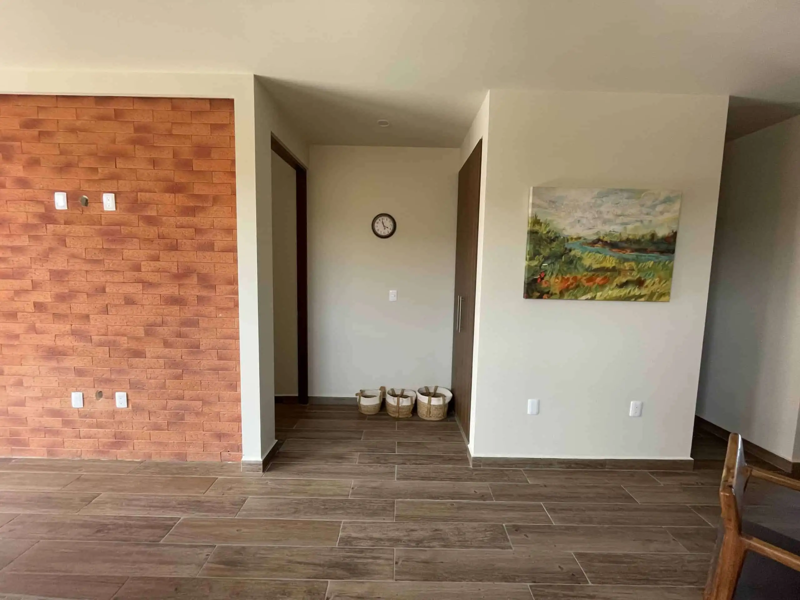 Spacious living area with stylish decor and natural light.