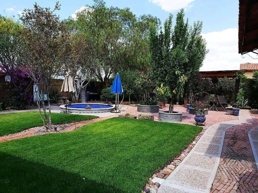 Beautiful outdoor garden with lush green lawn and mature trees in Rancho Los Labradores.