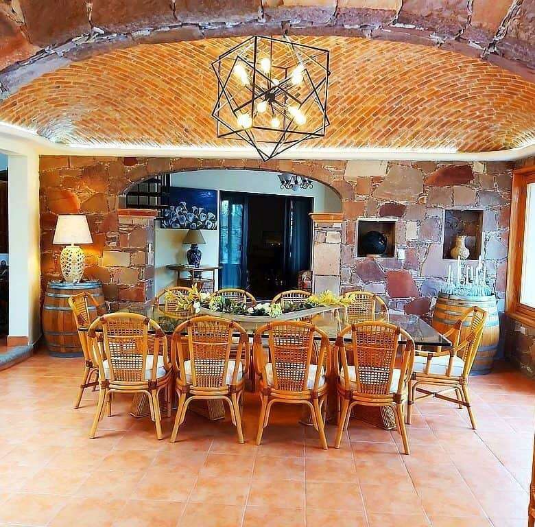 Outdoor dining space with exposed brick arches and natural light.