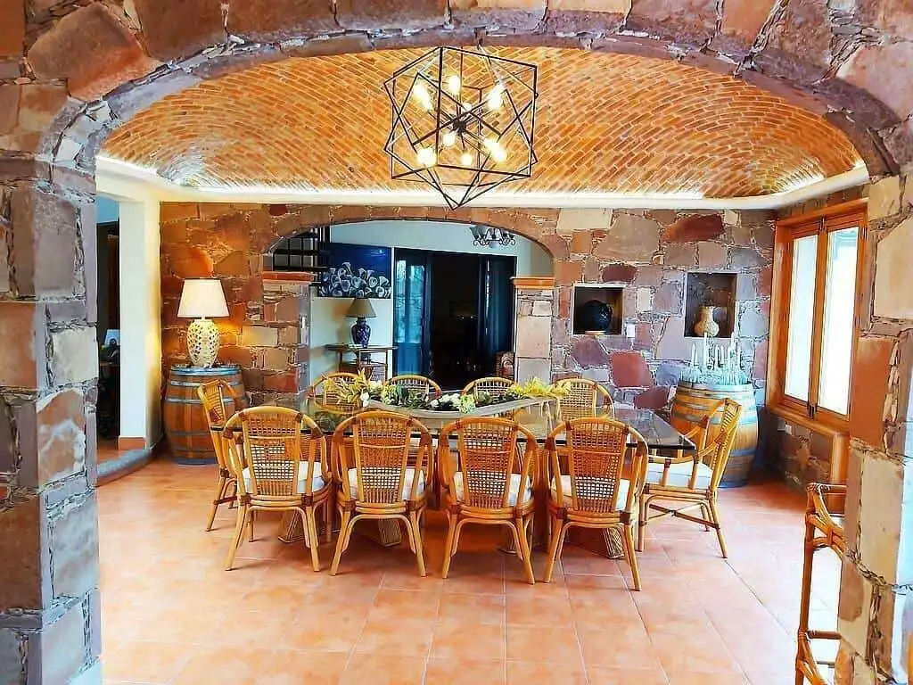 Outdoor dining space with exposed brick arches and natural light.