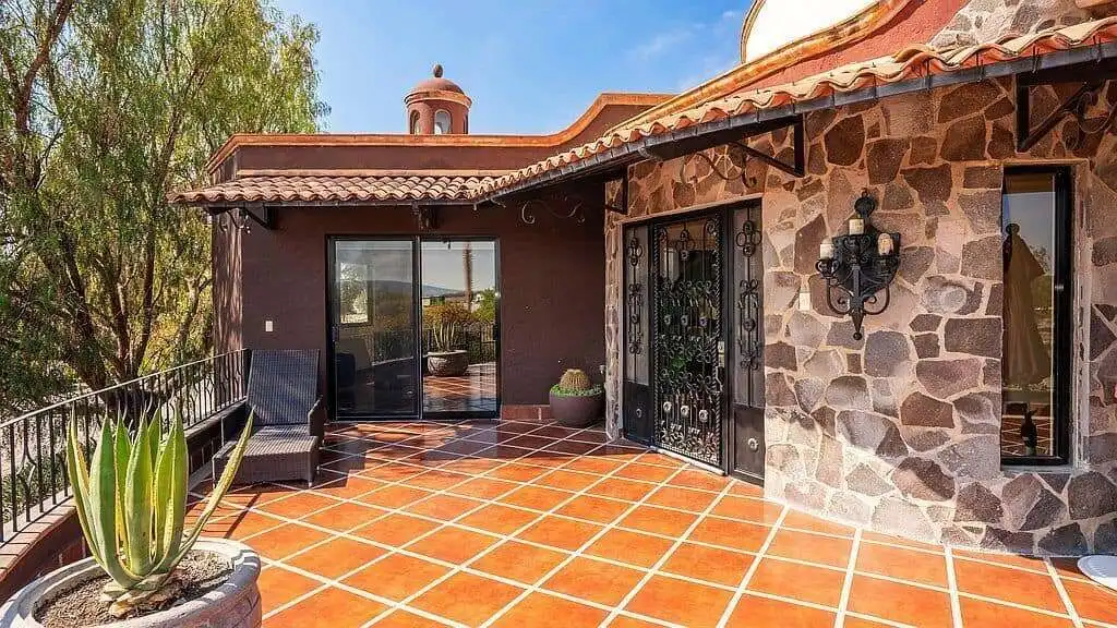Elegant lakeside estate with stone accents and spacious terrace in Rancho Los Labradores.
