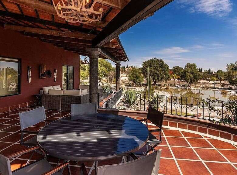 Outdoor terrace with river view and seating area for relaxation.