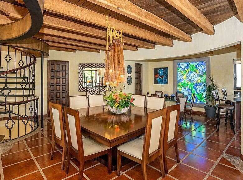 Luxury Spanish villa interior featuring a spiral staircase and elegant dining area.