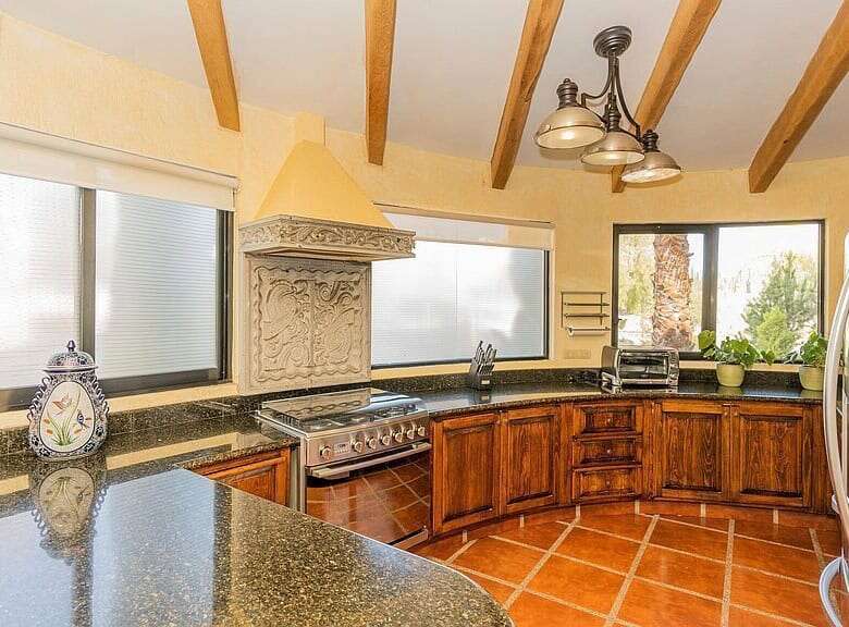 Spacious lakeside kitchen with wooden cabinets, modern appliances, and natural light in Rancho Los L.
