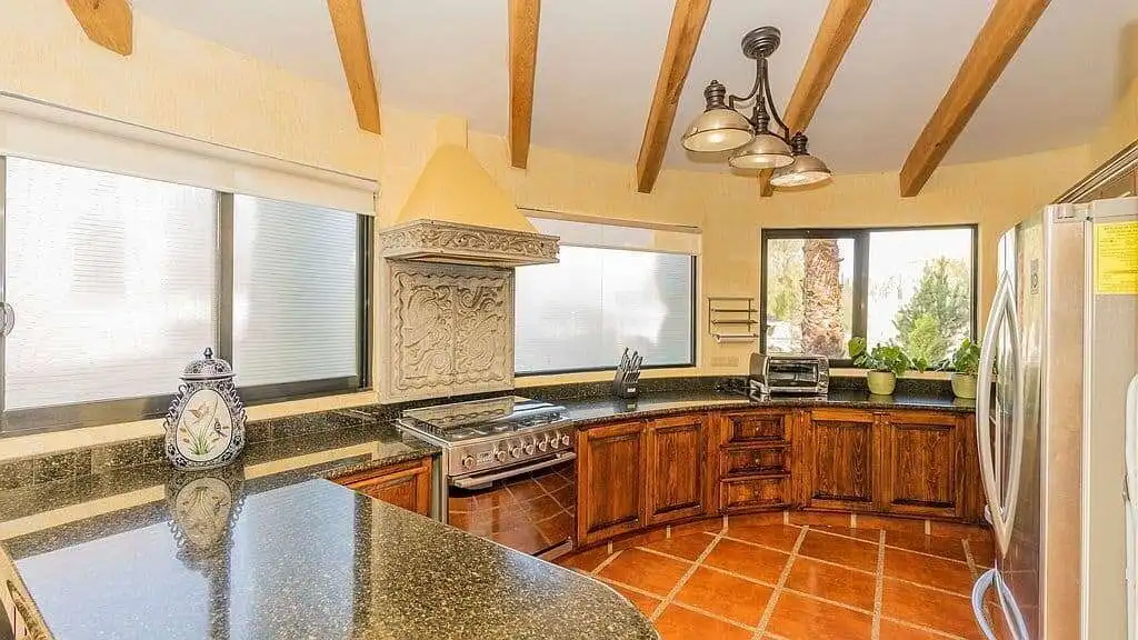 Spacious lakeside kitchen with wooden cabinets, modern appliances, and natural light in Rancho Los L.