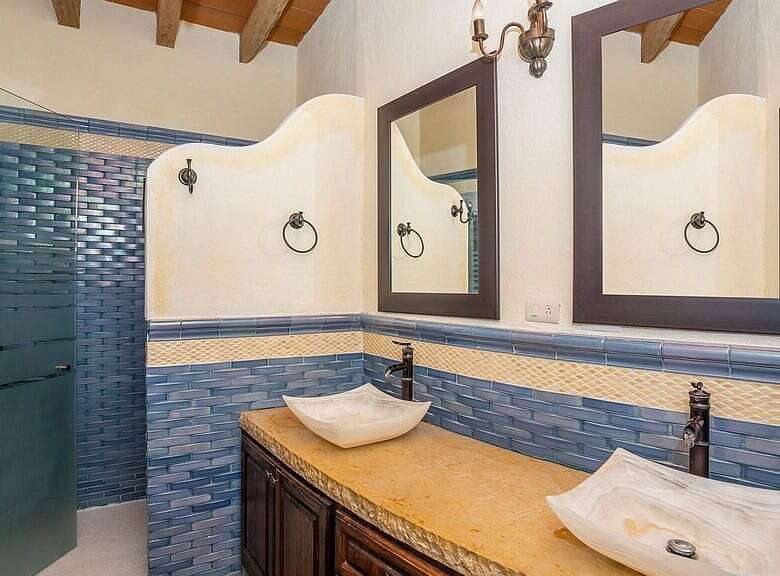 Elegant lakeside estate bathroom with dual vessel sinks and modern fixtures.