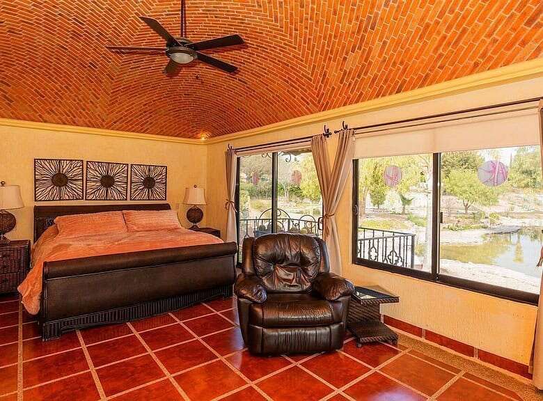 Cozy bedroom with lakeside view in Rancho Los Labradores estate.