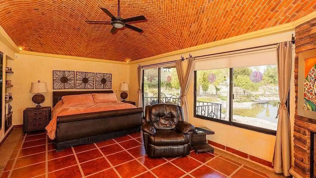 Cozy bedroom with lakeside view in Rancho Los Labradores estate.