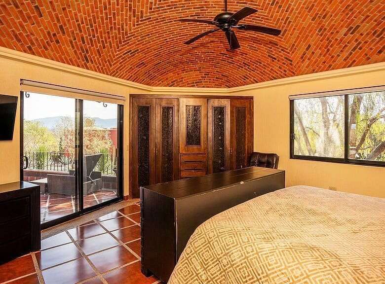 Elegant lakeside estate living room with brick vaulted ceiling and large windows in Rancho Los Labra.