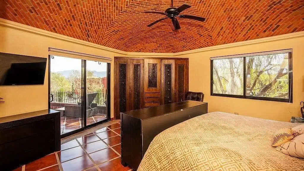 Elegant lakeside estate living room with brick vaulted ceiling and large windows in Rancho Los Labra.