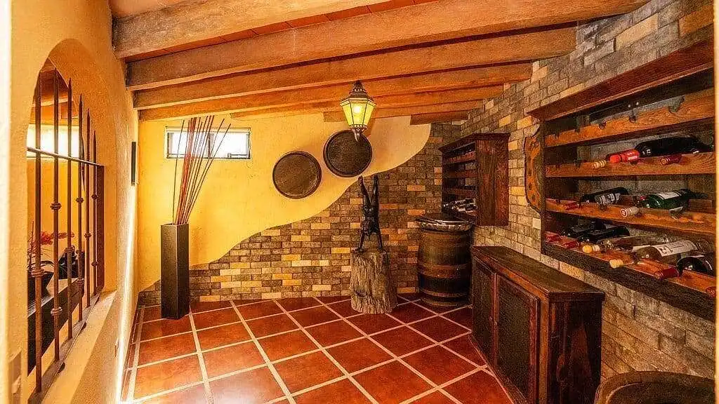 Elegant wine cellar with wooden racks and stone walls in a lakeside estate.