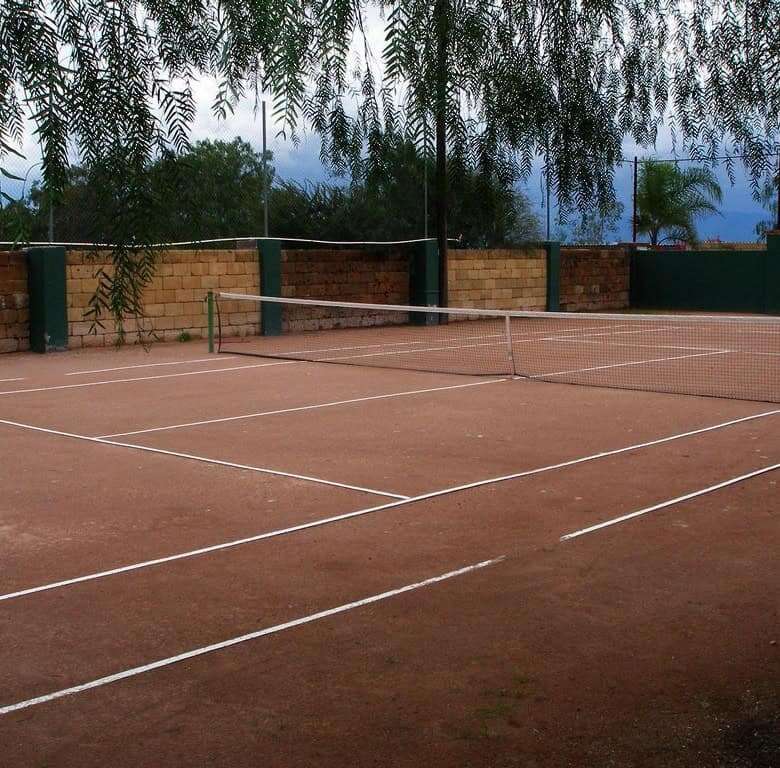 Lakeside tennis court at Rancho Los Labradores estate in San Miguel de Allende.