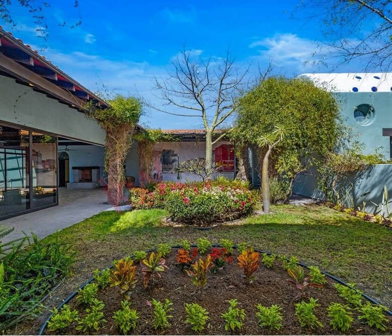 Beautiful landscaped garden featuring trees, shrubs, and vibrant flowers in a contemporary home sett.