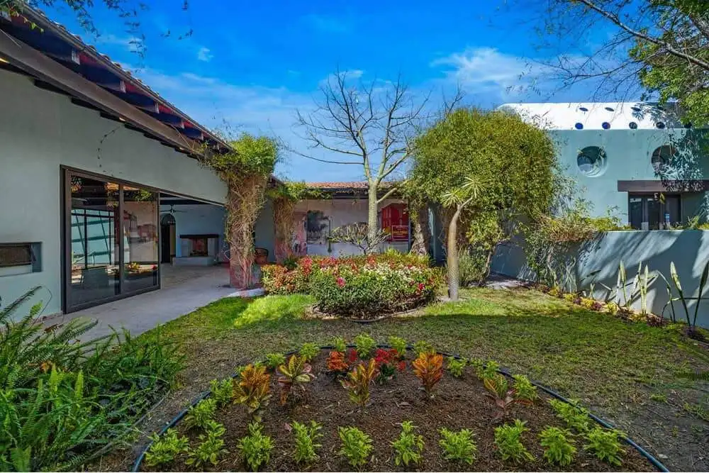 Beautiful landscaped garden featuring trees, shrubs, and vibrant flowers in a contemporary home sett.