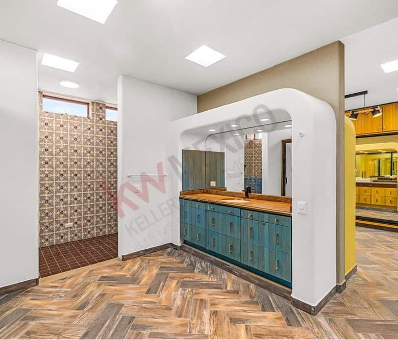 Bright, contemporary kitchen with vibrant blue cabinets and unique interior decor.