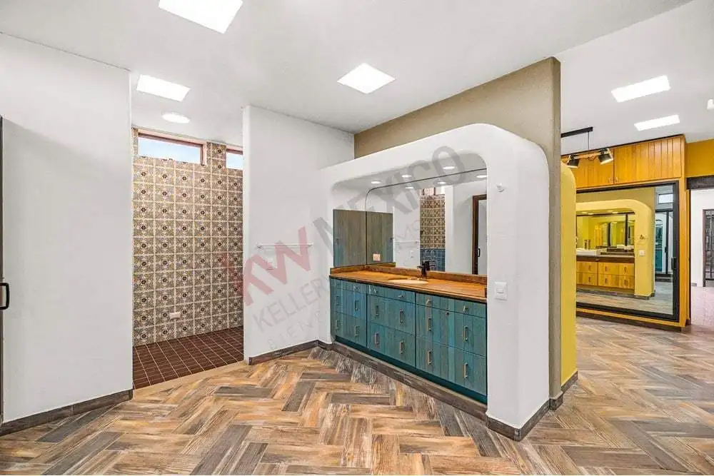 Bright, contemporary kitchen with vibrant blue cabinets and unique interior decor.