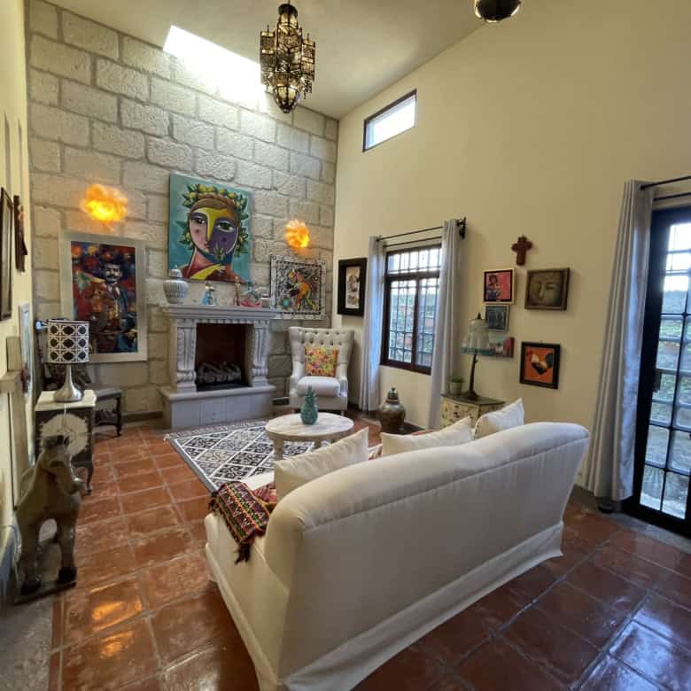 Bright living room with artwork, fireplace, and large glass doors for natural light.