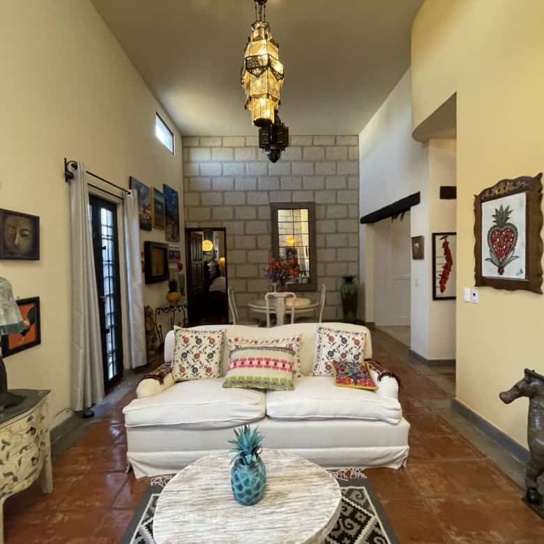 Cozy living room featuring eclectic artwork, vintage furniture, and vibrant accents in a stylish hom.