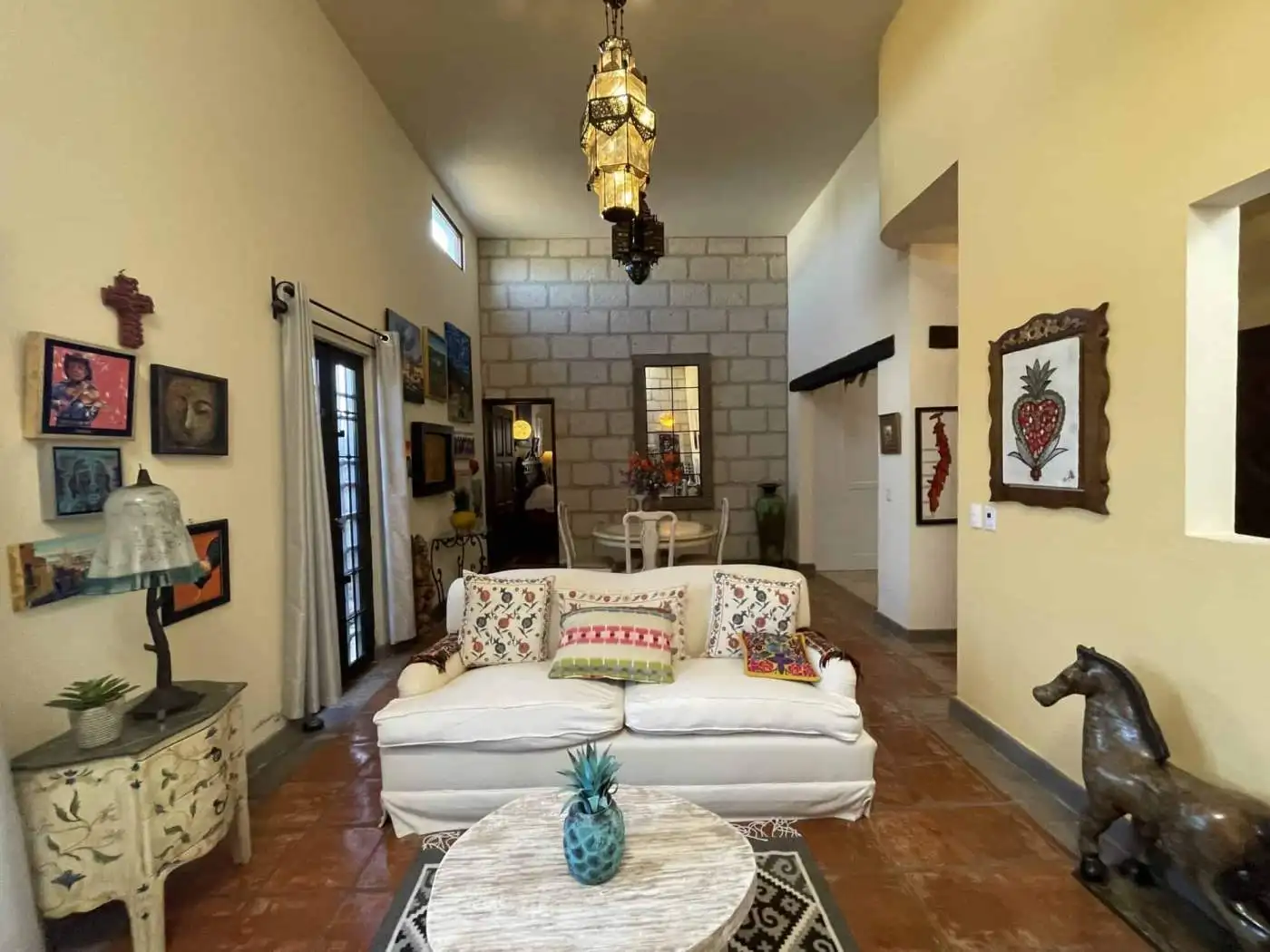 Cozy living room featuring eclectic artwork, vintage furniture, and vibrant accents in a stylish hom.
