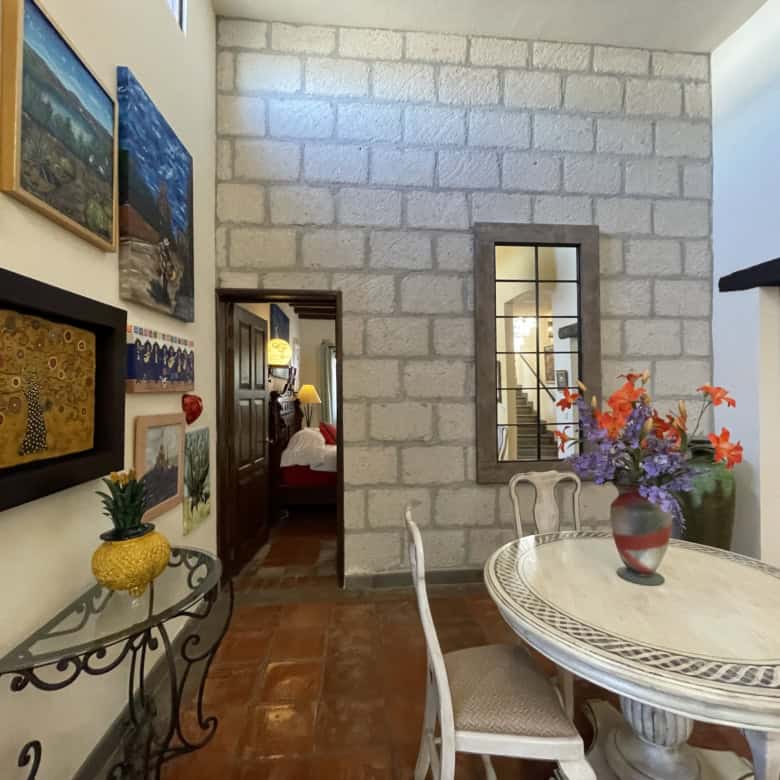 Cozy dining area featuring a round table and floral centerpiece in a stylish home interior.