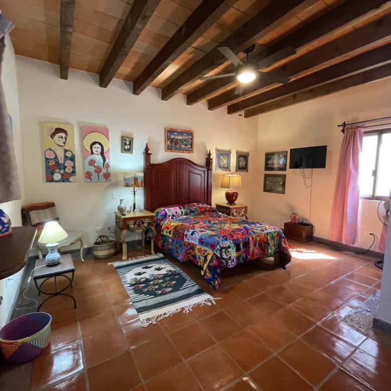 Rustic country house with wooden ceiling and colorful decor in a spacious, bright interior.