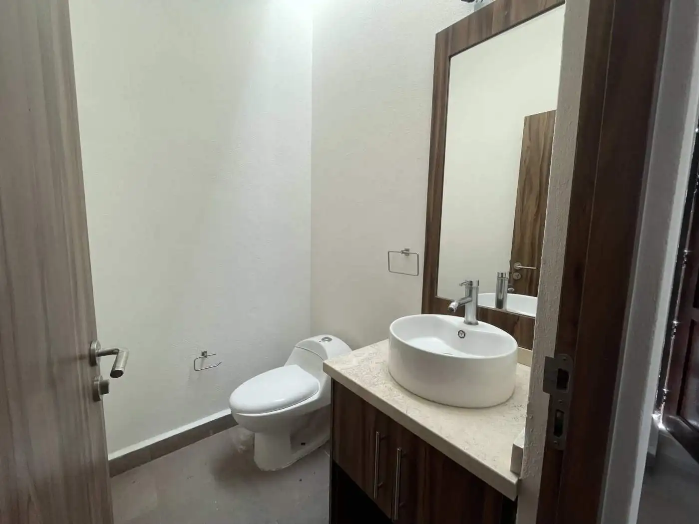 Bathroom with modern toilet and stylish vessel sink in a contemporary home.