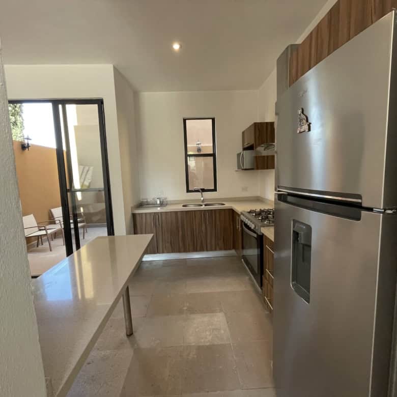 Modern kitchen with stainless steel appliances and wooden cabinets.