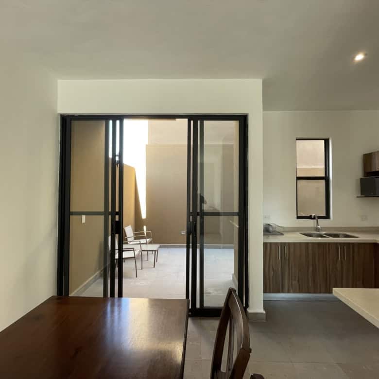 Modern kitchen with balcony access and open-plan design.