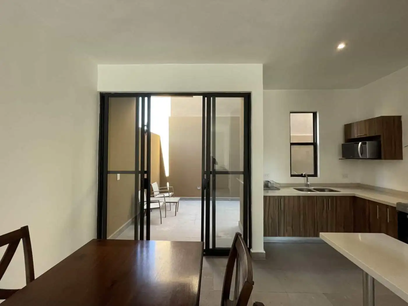 Modern kitchen with balcony access and open-plan design.