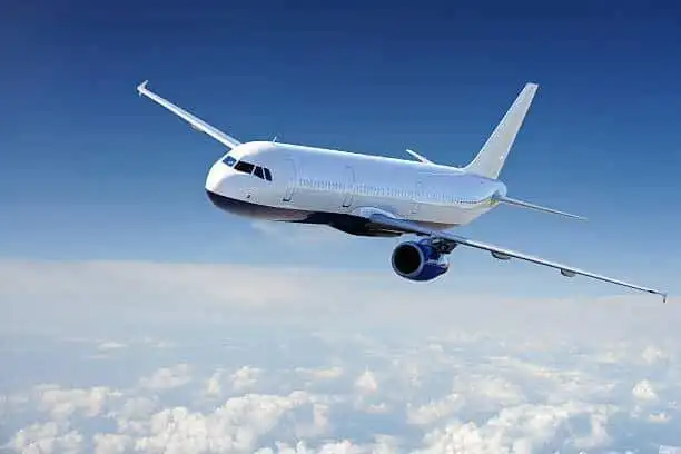 Private jet soaring through the sky above clouds, representing luxury travel and international prope.