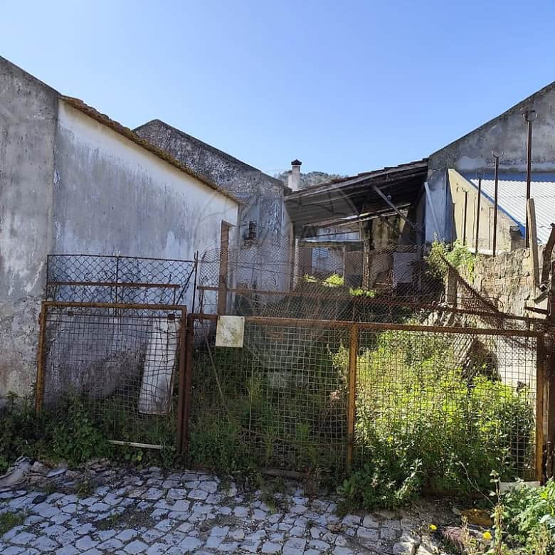 Empty plot of land enclosed by a rusty fence in Cabanas Setubal Portugal, suitable for building or d.