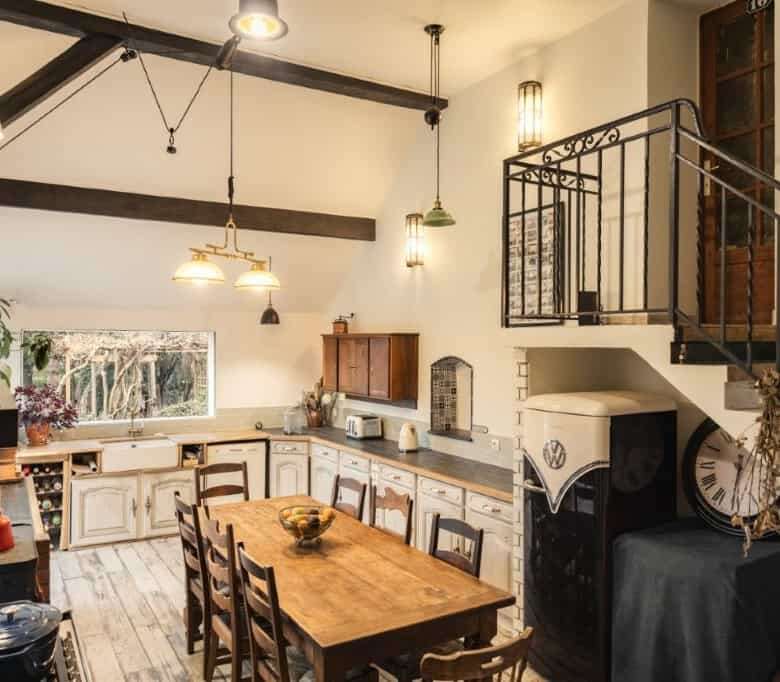 Cozy kitchen with rustic wooden dining table and vintage decor in a 6-bed estate in La Celle-sur-Mor.