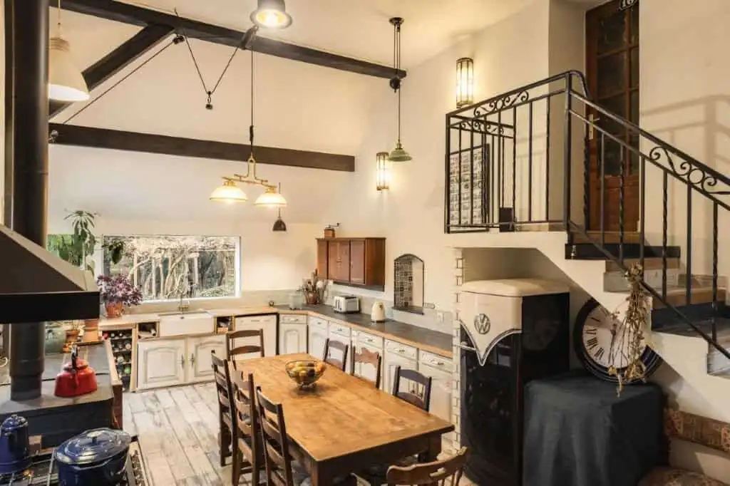 Cozy kitchen with rustic wooden dining table and vintage decor in a 6-bed estate in La Celle-sur-Mor.