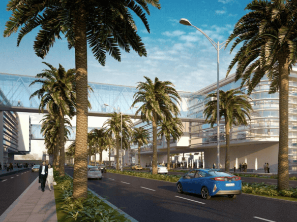 Urban development in Gwadar Pakistan with palm trees, modern buildings, and a busy street scene.