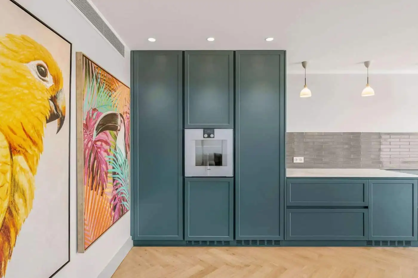 Stylish blue kitchen cabinetry with integrated appliances and vibrant animal art.